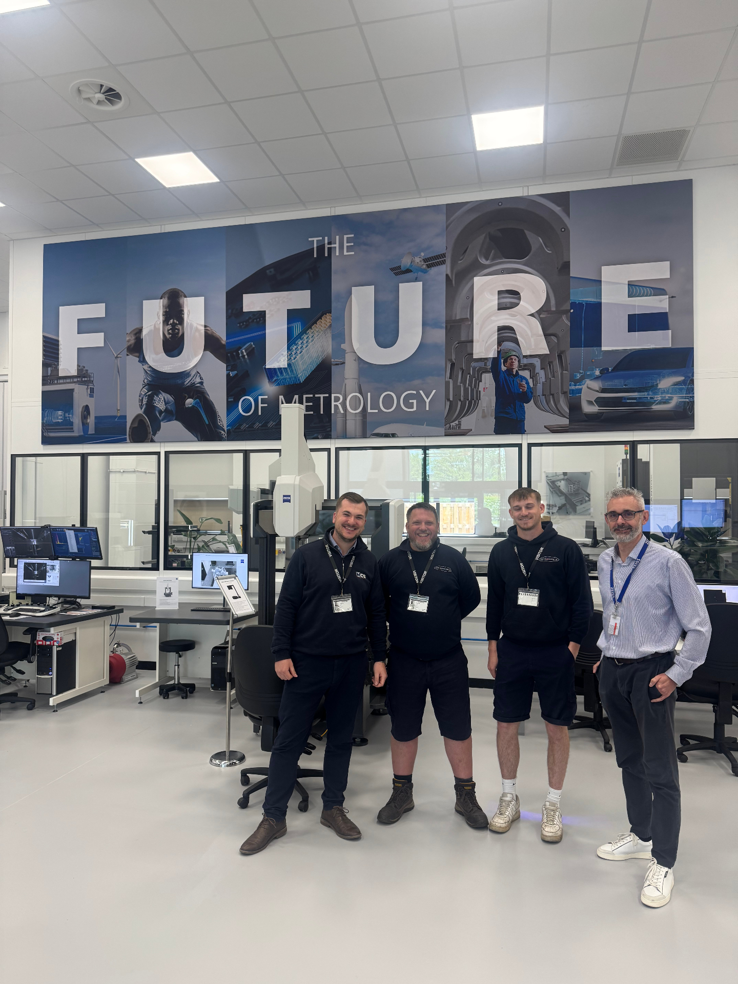 DGF Engineering team with Measurement Consulting Specialists at the ZEISS UK metrology centre, standing in front of the Future of Metrology wall